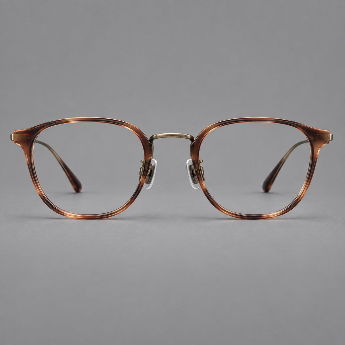 Retro soft square eyeglasses in acetate and titanium with a curved bridge and slender temples in Amber Tortoiseshell / Antique Gold, front view