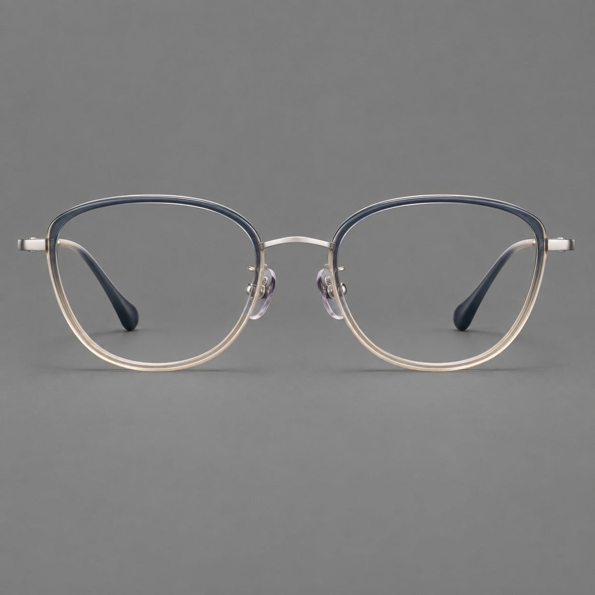 Upswept eyeglasses in acetate and titanium with softly rounded rims and tapered metal temples in Blue Tea Gradient / Gunmetal, front view