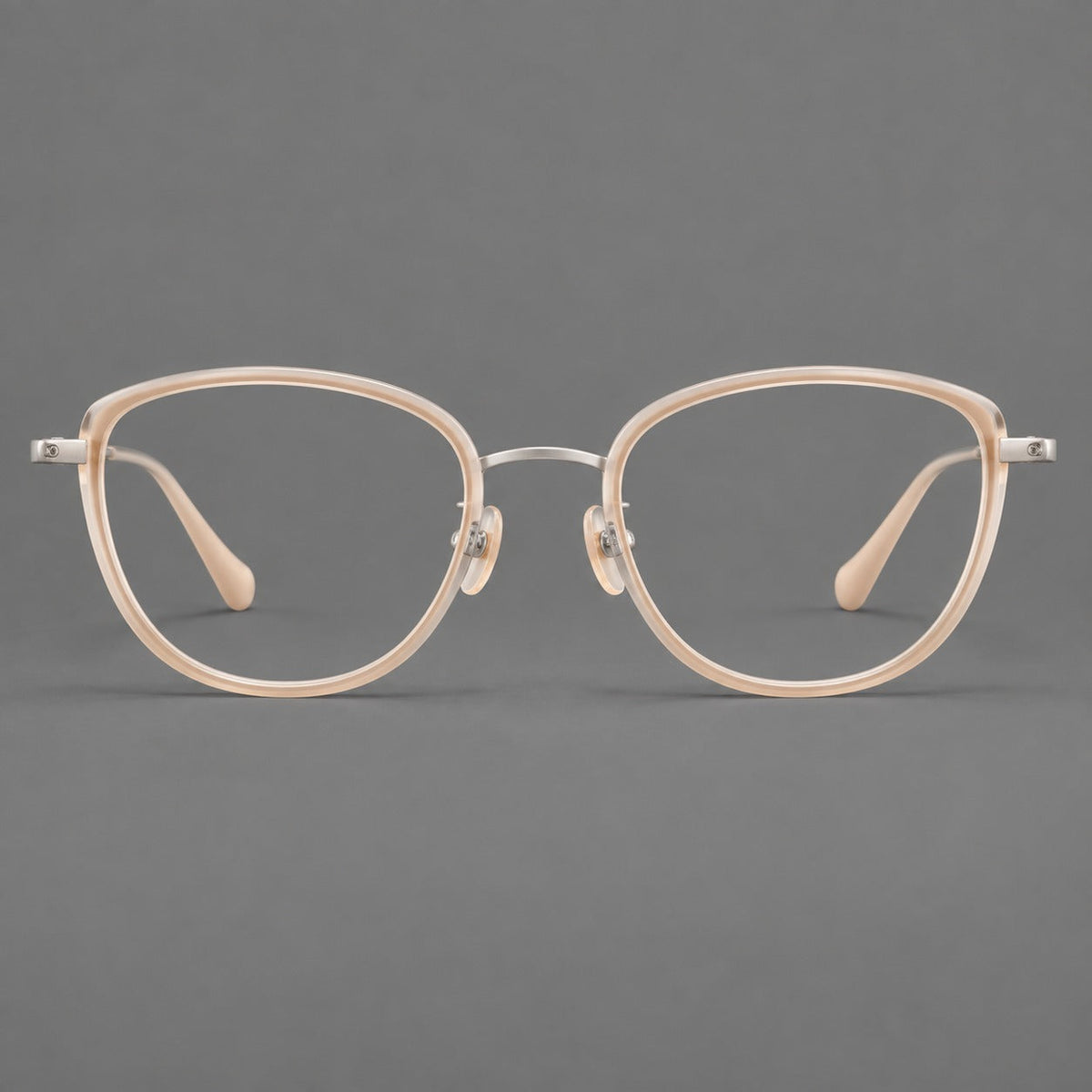 Upswept eyeglasses in acetate and titanium with softly rounded rims and tapered metal temples in Nude Pink / Silver, front view