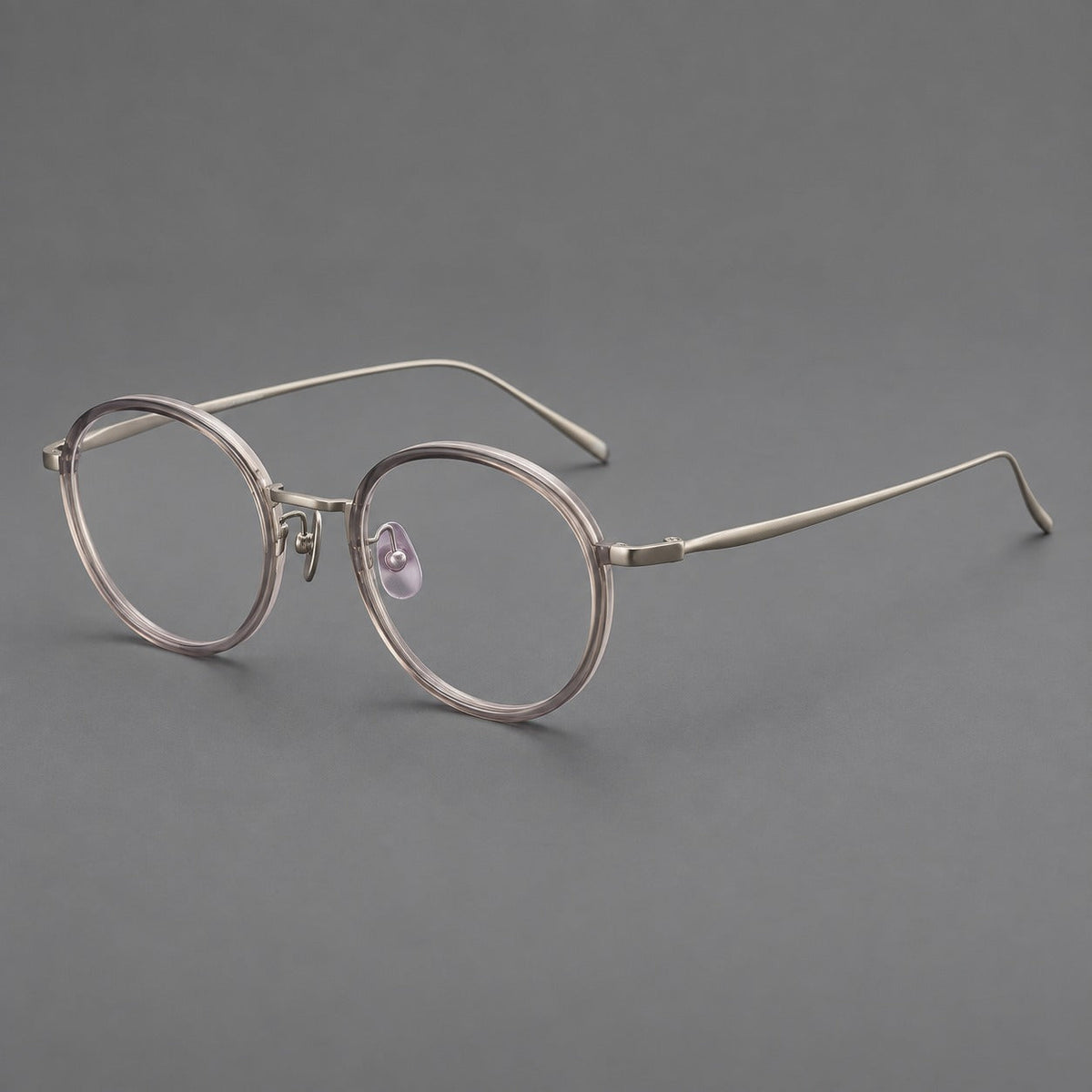 Classic round eyeglasses in acetate and titanium with slim rims and textured metal temples in Gray Pink Gradient / Gunmetal, three quarter view