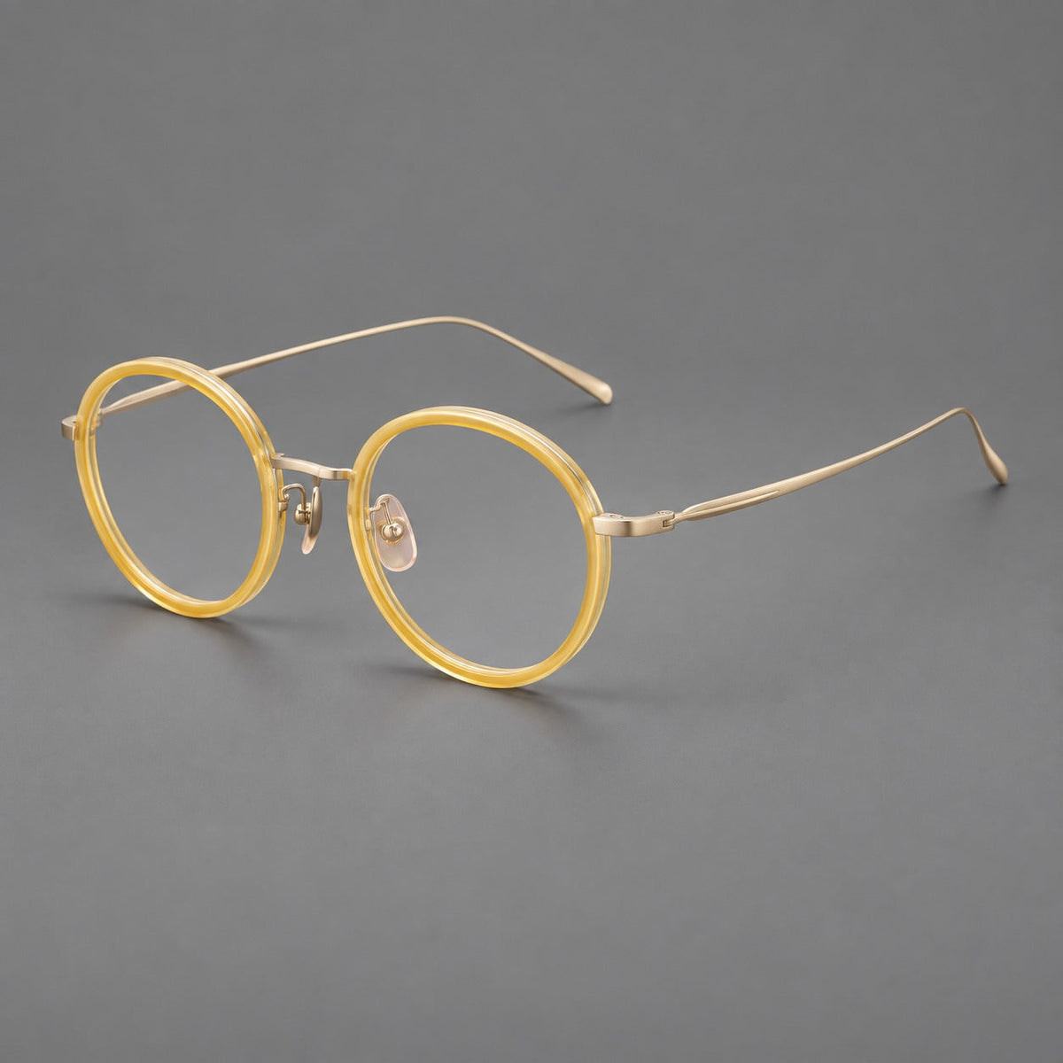 Classic round eyeglasses in acetate and titanium with slim rims and textured metal temples in Lemon Yellow / Gold, three quarter view