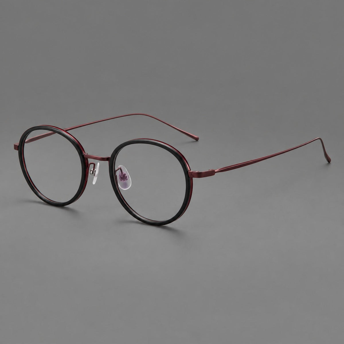 Classic round eyeglasses in acetate and titanium with slim rims and textured metal temples in Glossy Black / Wine Red, three quarter view
