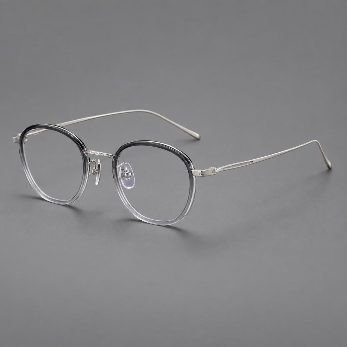 Vintage round eyeglasses in acetate and titanium with an engraved bridge and slender temples in Gray Gradient / Silver, three quarter view