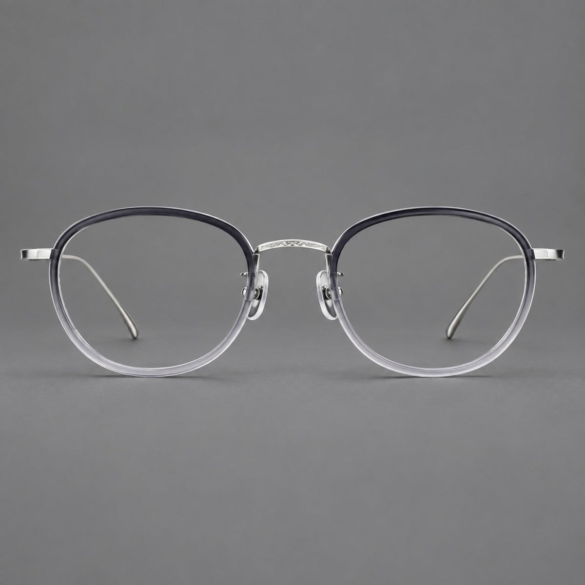 Vintage round eyeglasses in acetate and titanium with an engraved bridge and slender temples in Gray Gradient / Silver, front view