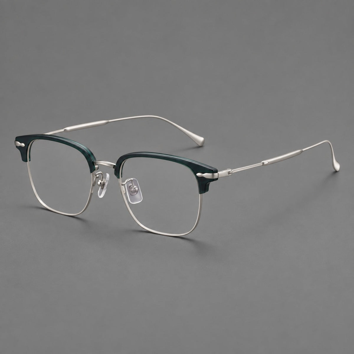 Browline eyeglasses in acetate and titanium with slim metal lower rims and decorative corners in Peacock Blue / Silver, three quarter view