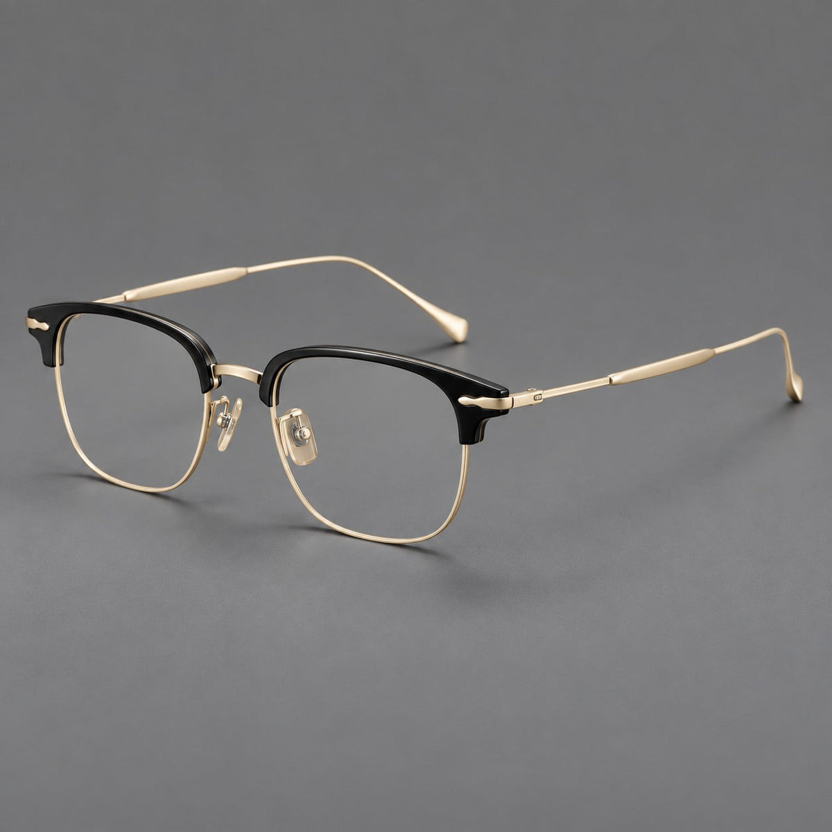 Browline eyeglasses in acetate and titanium with slim metal lower rims and decorative corners in Glossy Black / Gold, three quarter view