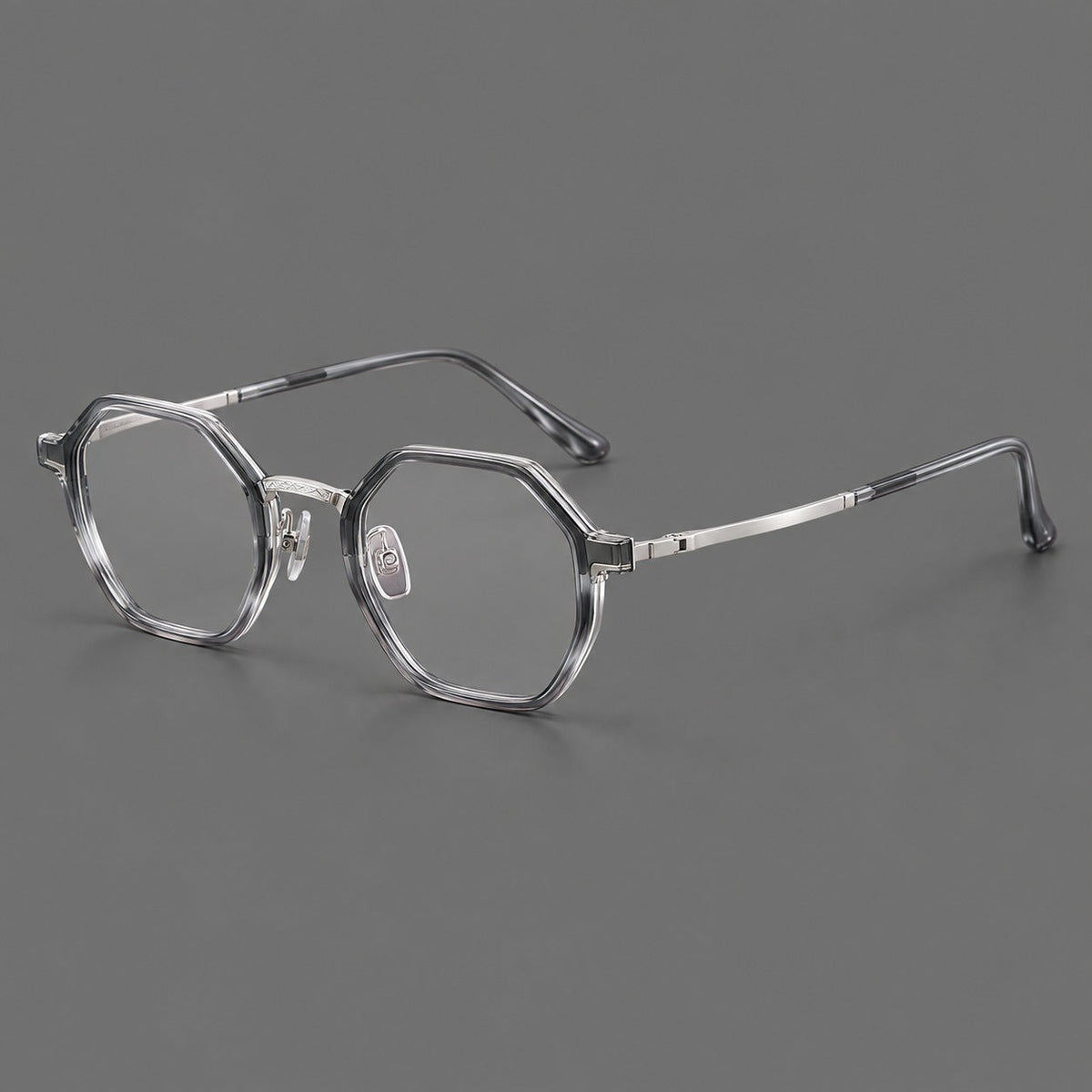 Geometric eyeglasses in acetate and titanium with octagonal rims and a textured metal bridge in Clear Mist Gray / Silver, three quarter view