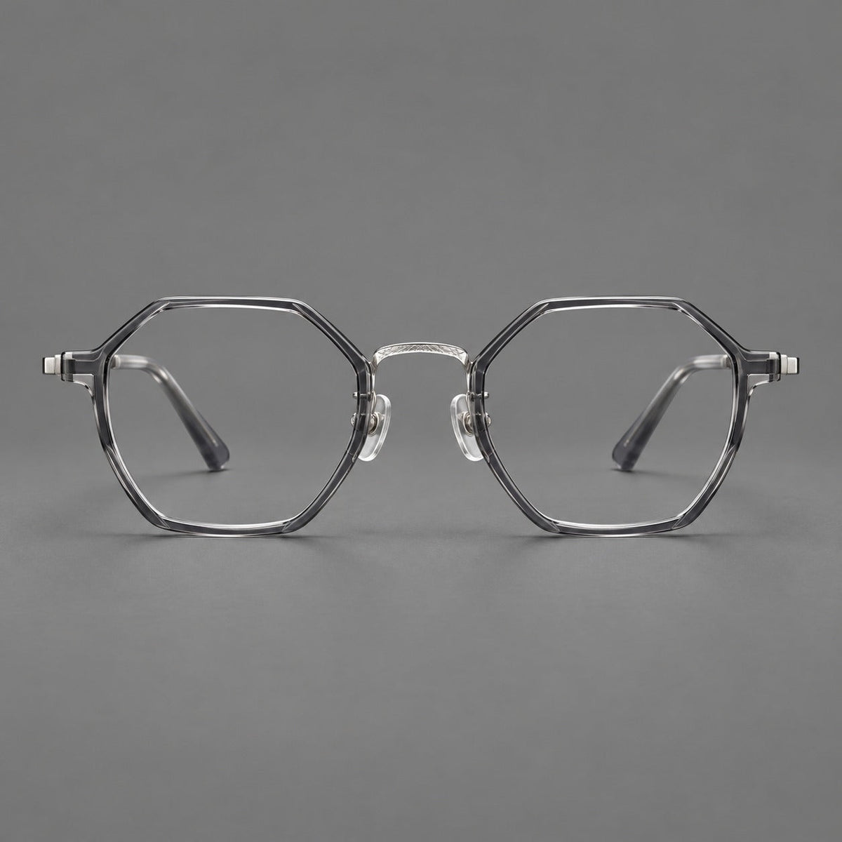 Geometric eyeglasses in acetate and titanium with octagonal rims and a textured metal bridge in Clear Mist Gray / Silver, front view