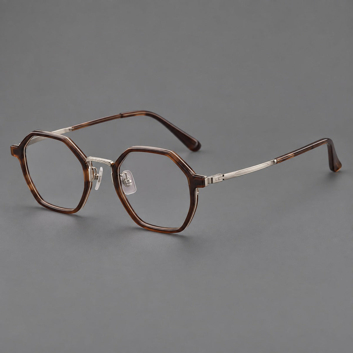 Geometric eyeglasses in acetate and titanium with octagonal rims and a textured metal bridge in Warm Tea Brown / Light Gunmetal, three quarter view