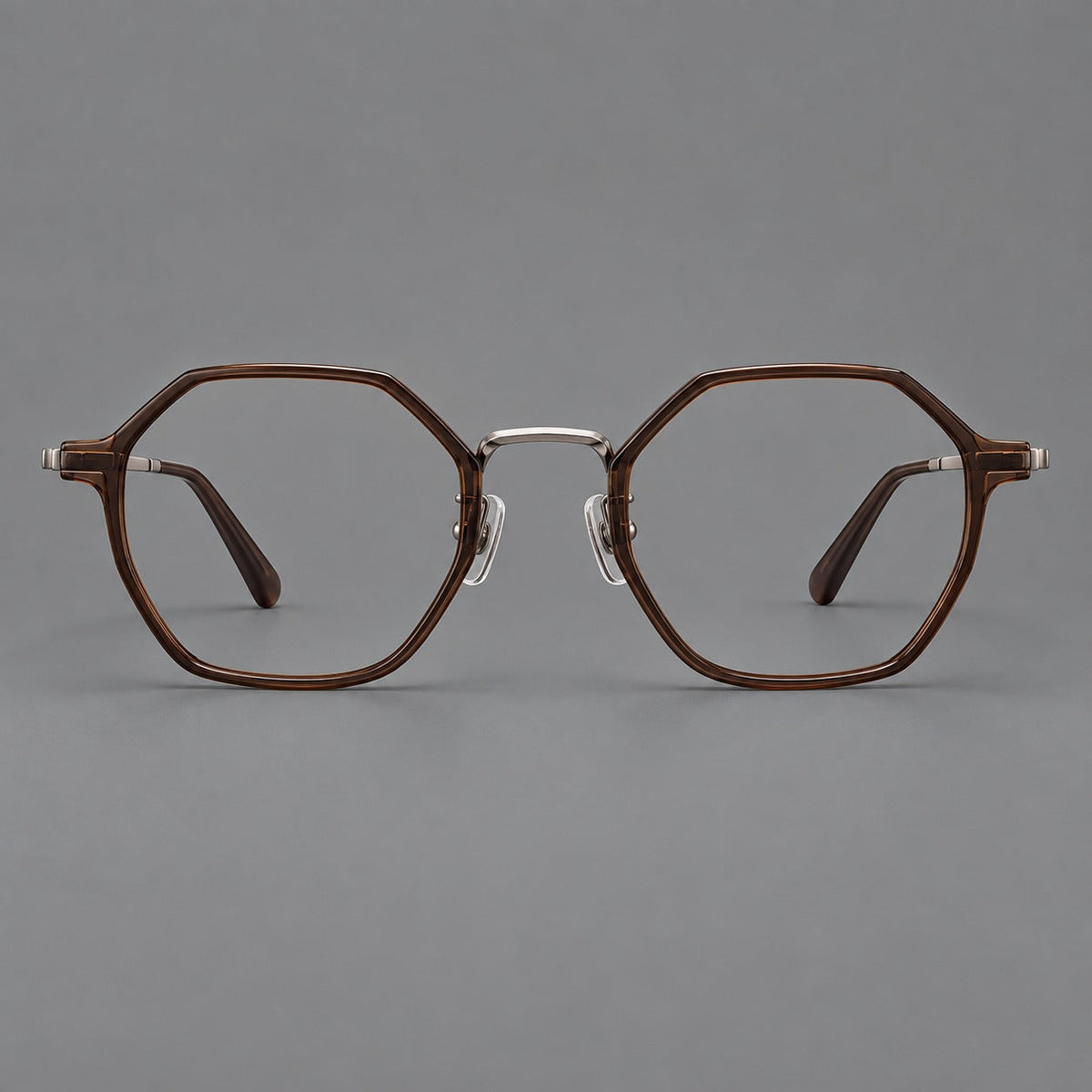 Geometric eyeglasses in acetate and titanium with octagonal rims and a textured metal bridge in Warm Tea Brown / Light Gunmetal, front view