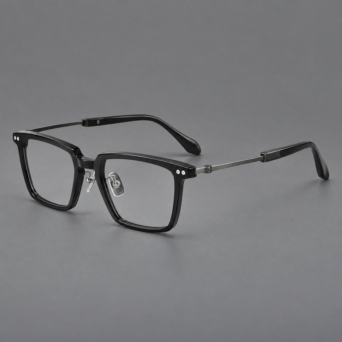 Classic acetate and titanium eyeglasses with a straight brow and rounded rectangular rims in Black / Brushed Gray, three quarter view