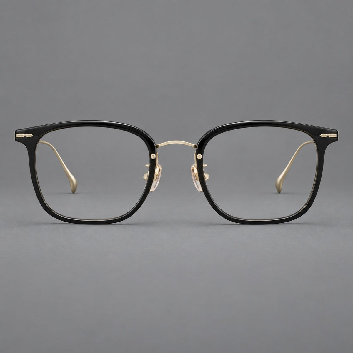 Retro square eyeglasses in acetate and titanium with rounded edges and sculpted corner accents in Glossy Black / Gold, front view