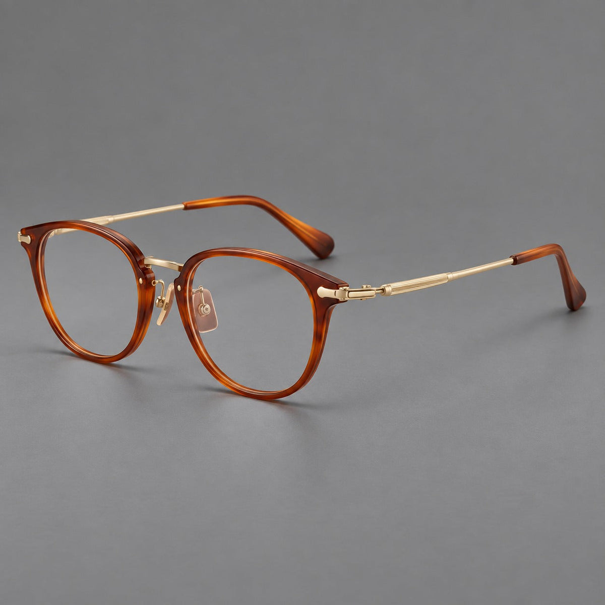 Classic soft square eyeglasses in acetate and titanium with engraved temples and corner accents in Amber Tortoiseshell / Gold, three quarter view