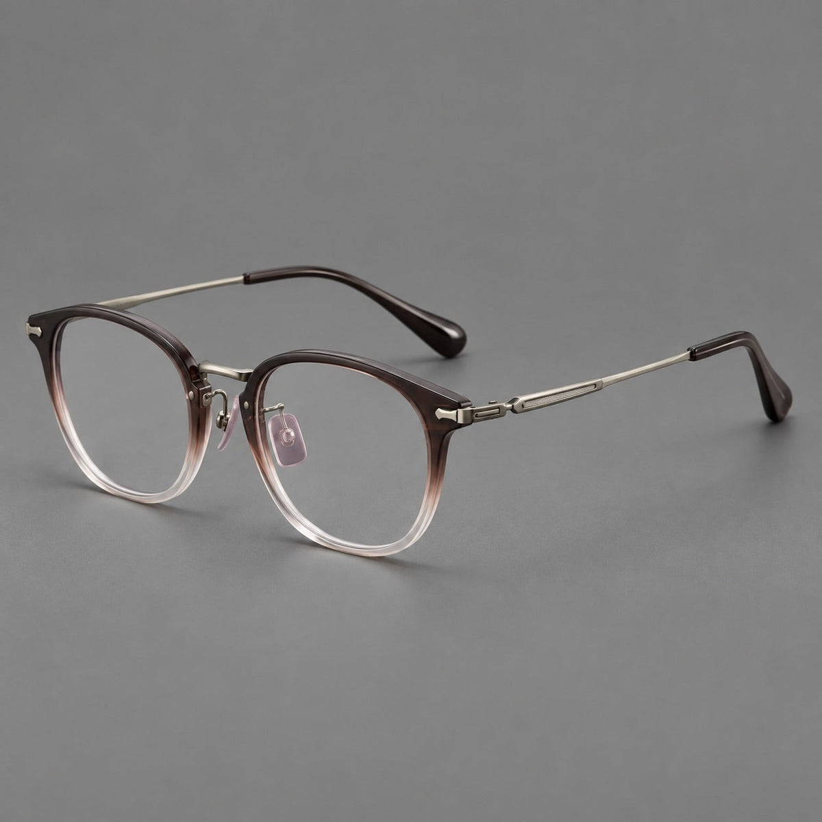 Classic soft square eyeglasses in acetate and titanium with engraved temples and corner accents in Tea Brown Gradient / Dark Gray, three quarter view
