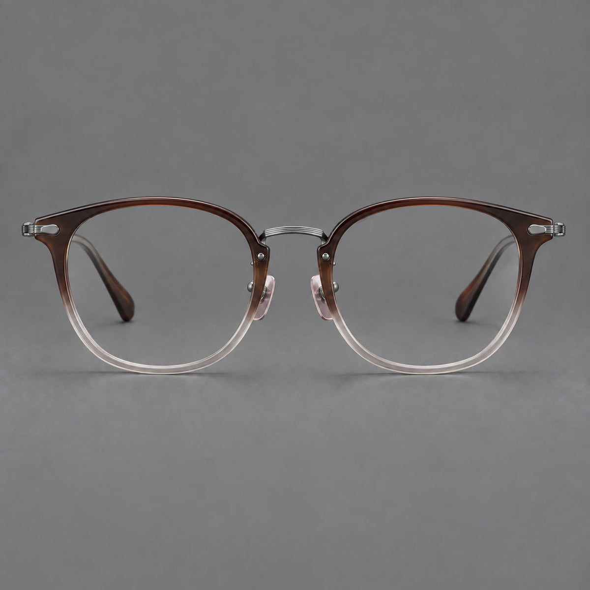 Classic soft square eyeglasses in acetate and titanium with engraved temples and corner accents in Tea Brown Gradient / Dark Gray, front view