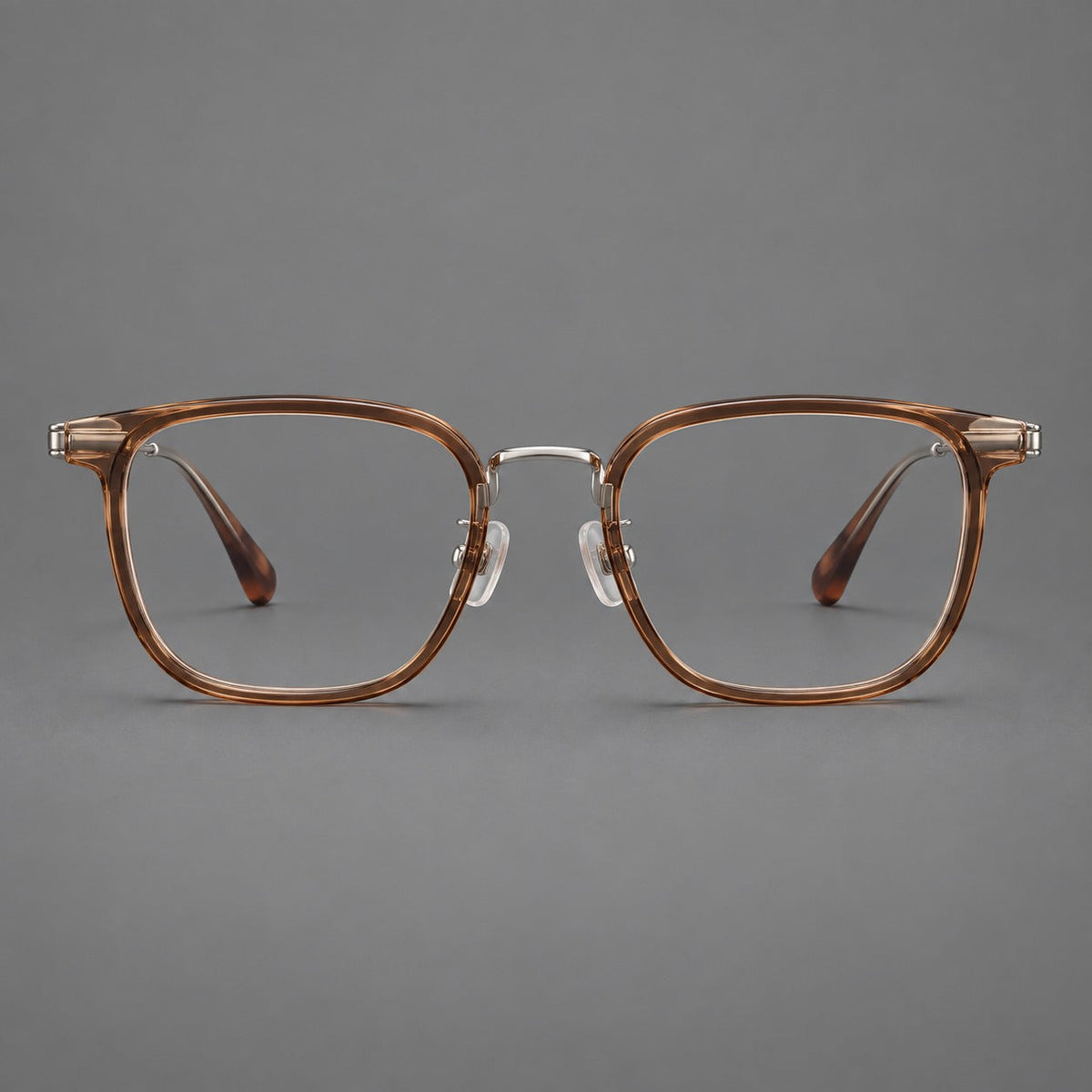 Soft square eyeglasses in acetate and titanium with wide upper corners and fine metal temples in Clear Tea / Silver, front view