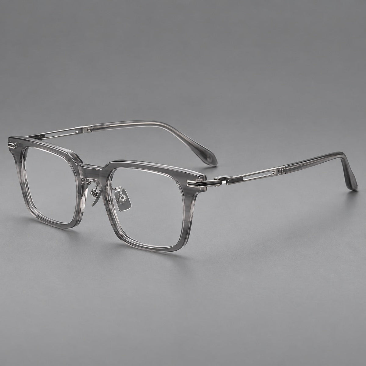 Modern acetate and titanium eyeglasses with angular square rims and curved metal hinges in Clear Gray, three quarter view