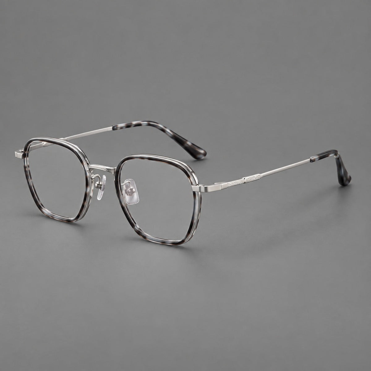 Soft square eyeglasses in acetate and titanium with slim rims and a finely engraved metal bridge in Gray Tortoiseshell / Silver, three quarter view