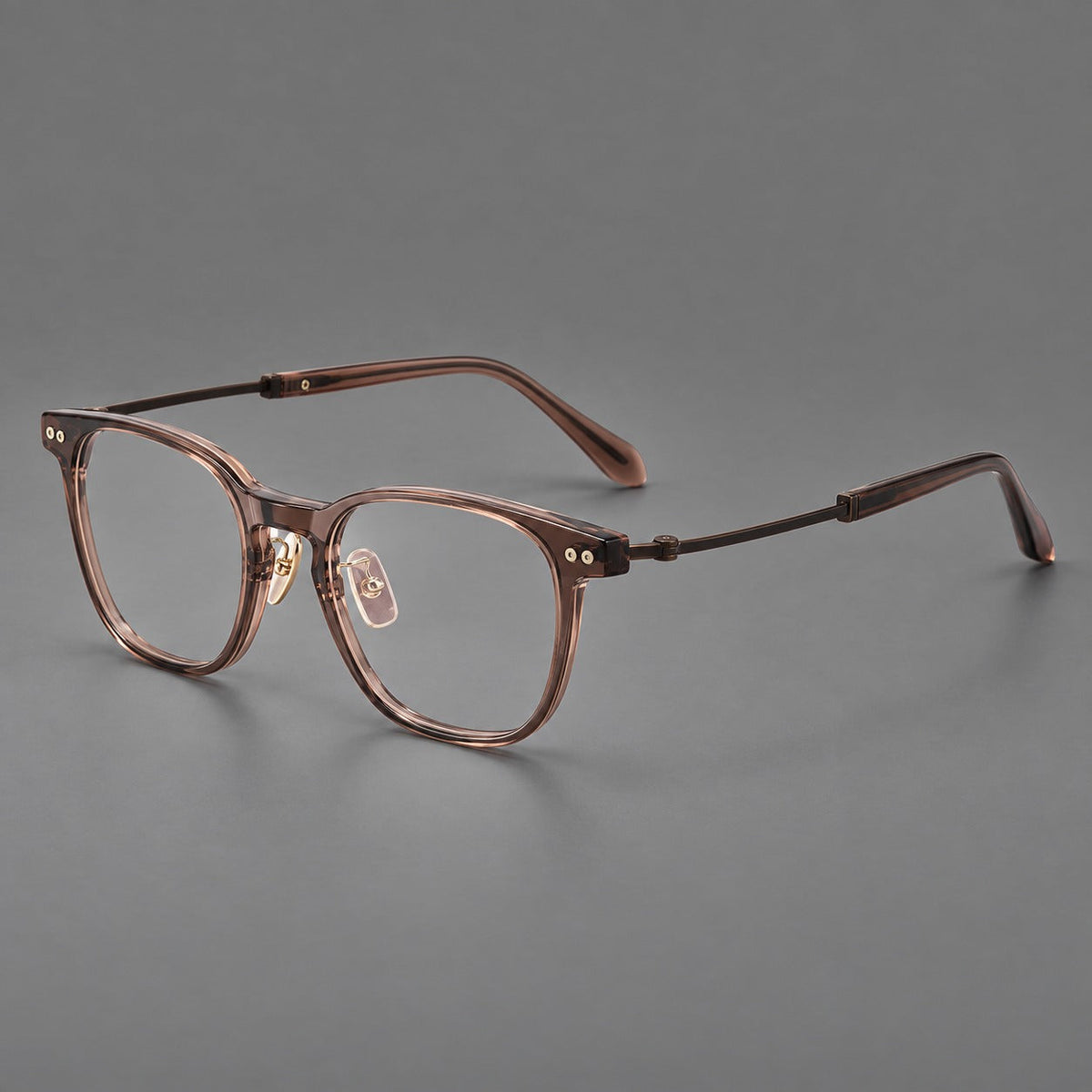 Vintage acetate and titanium eyeglasses with soft square rims and paired metal rivets in Clear Brown / Antique Bronze, three quarter view