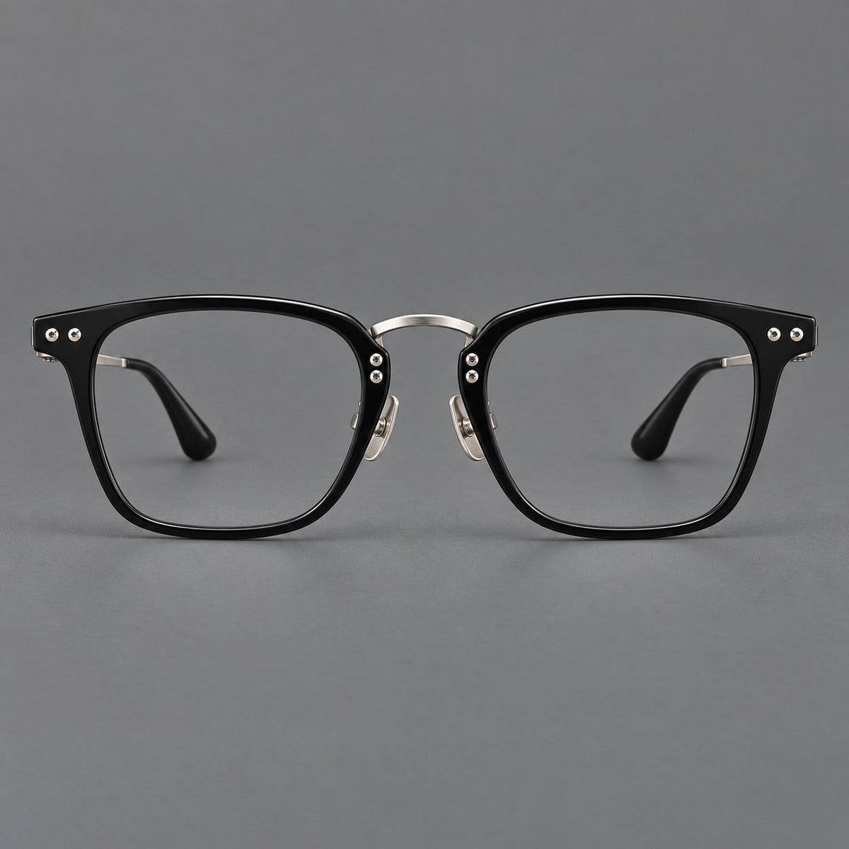 Acetate and titanium eyeglasses with soft square rims and an arched metal bridge in Black / Silver, front view
