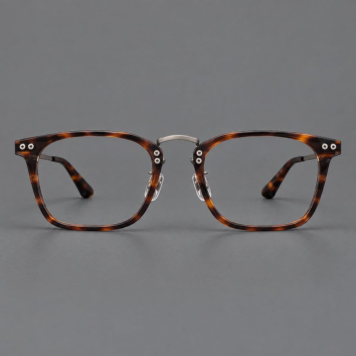 Acetate and titanium eyeglasses with angular rectangular rims and a curved metal bridge in Tortoiseshell / Gunmetal, front view