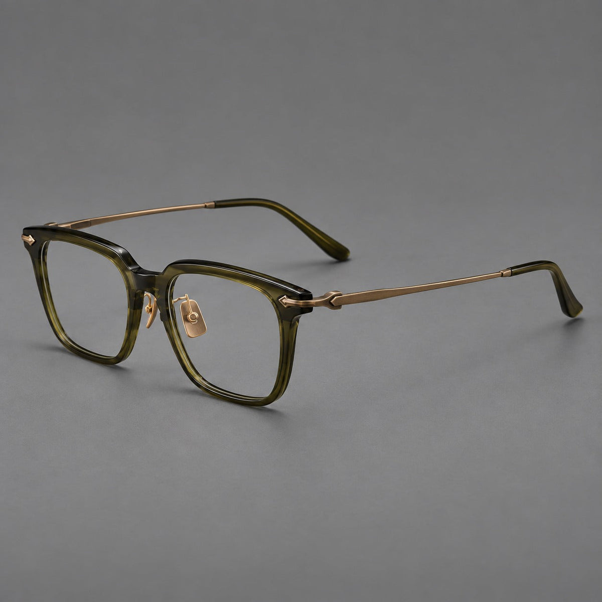 Bold acetate and titanium eyeglasses with rectangular rims and sculpted arrow accents in Army Green / Antique Bronze, three quarter view