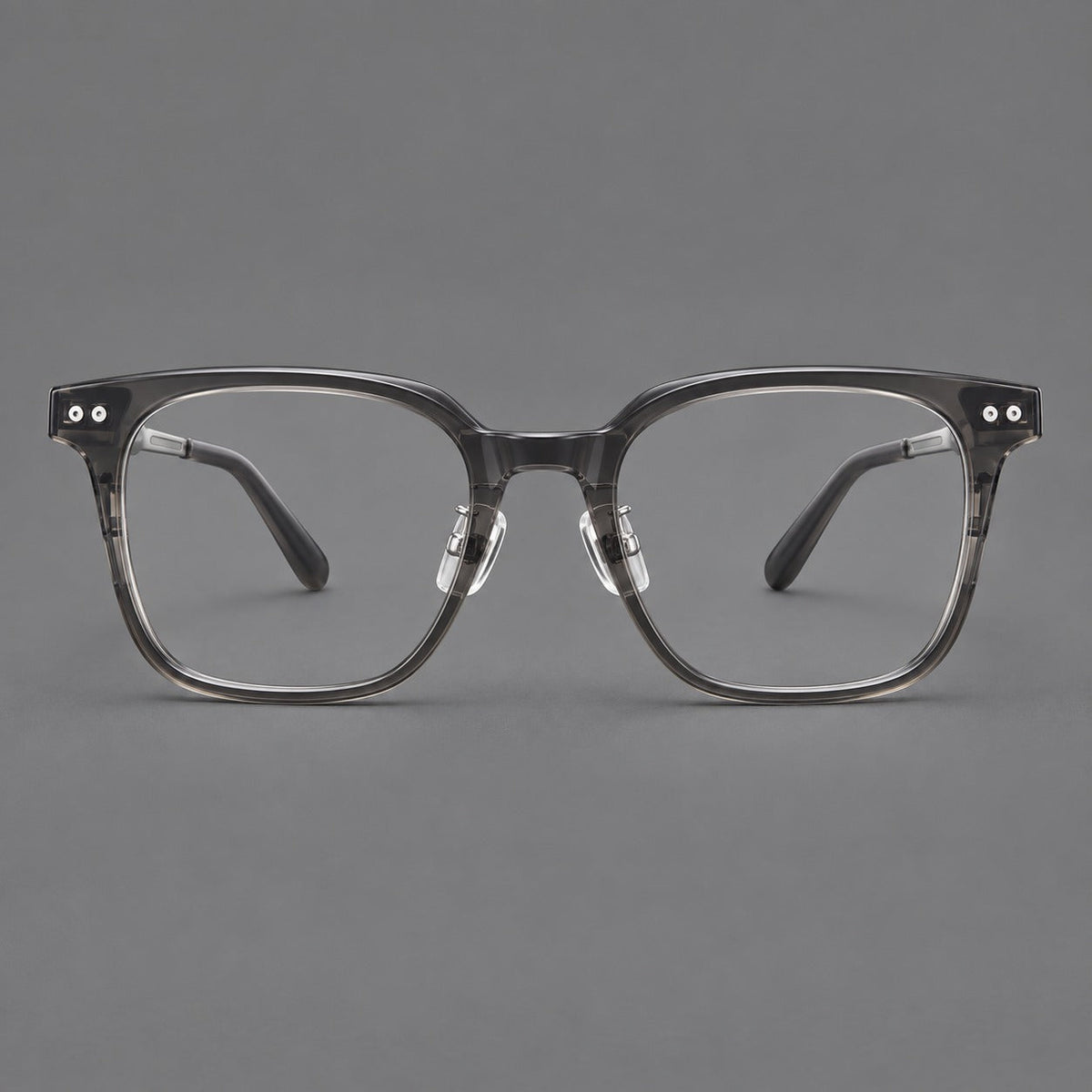 Classic acetate and titanium eyeglasses with squared brows and paired corner rivets in Clear Gray / Silver, front view