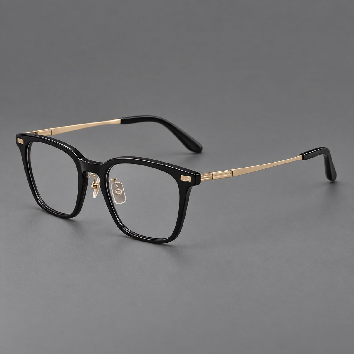 Classic acetate and titanium eyeglasses with rounded square rims and textured corner accents in Black / Gold, three quarter view
