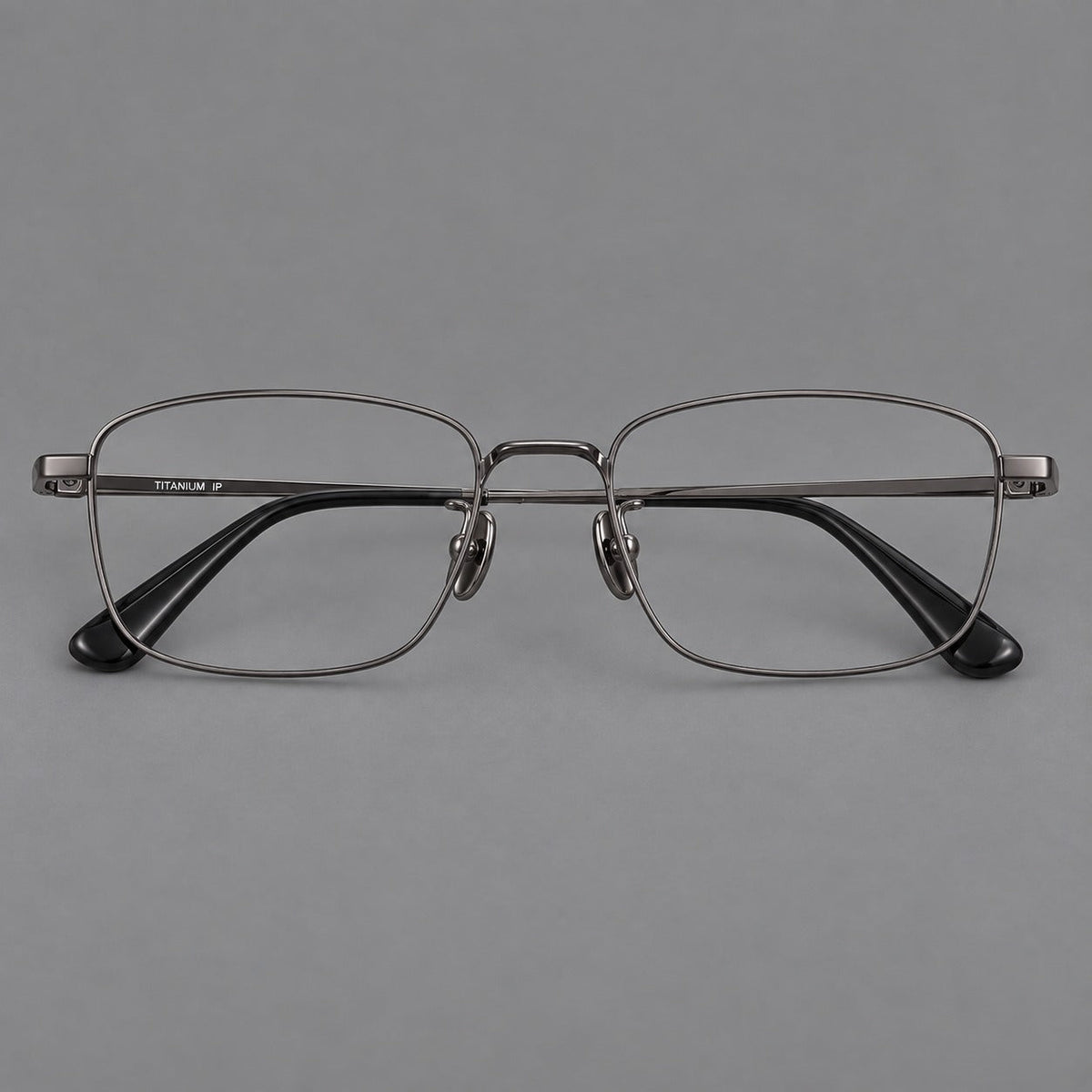 Modern square titanium glasses with an angular bridge and broad straight temples in Gunmetal, front view