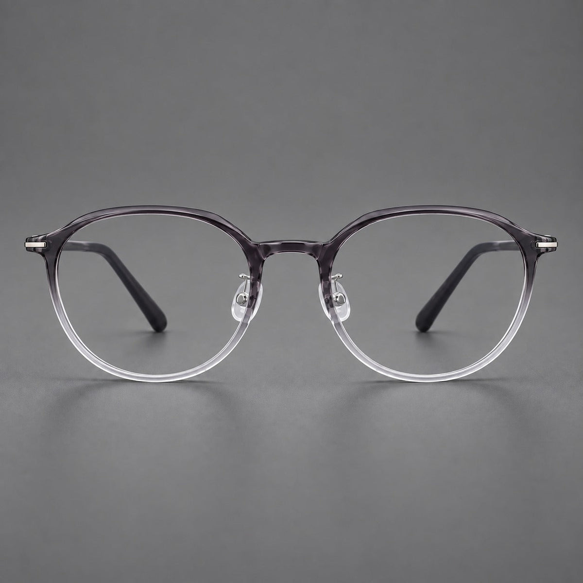 Retro round plastic eyeglasses with a curved bridge and slim metal corner accents in Ink Gray Gradient, front view