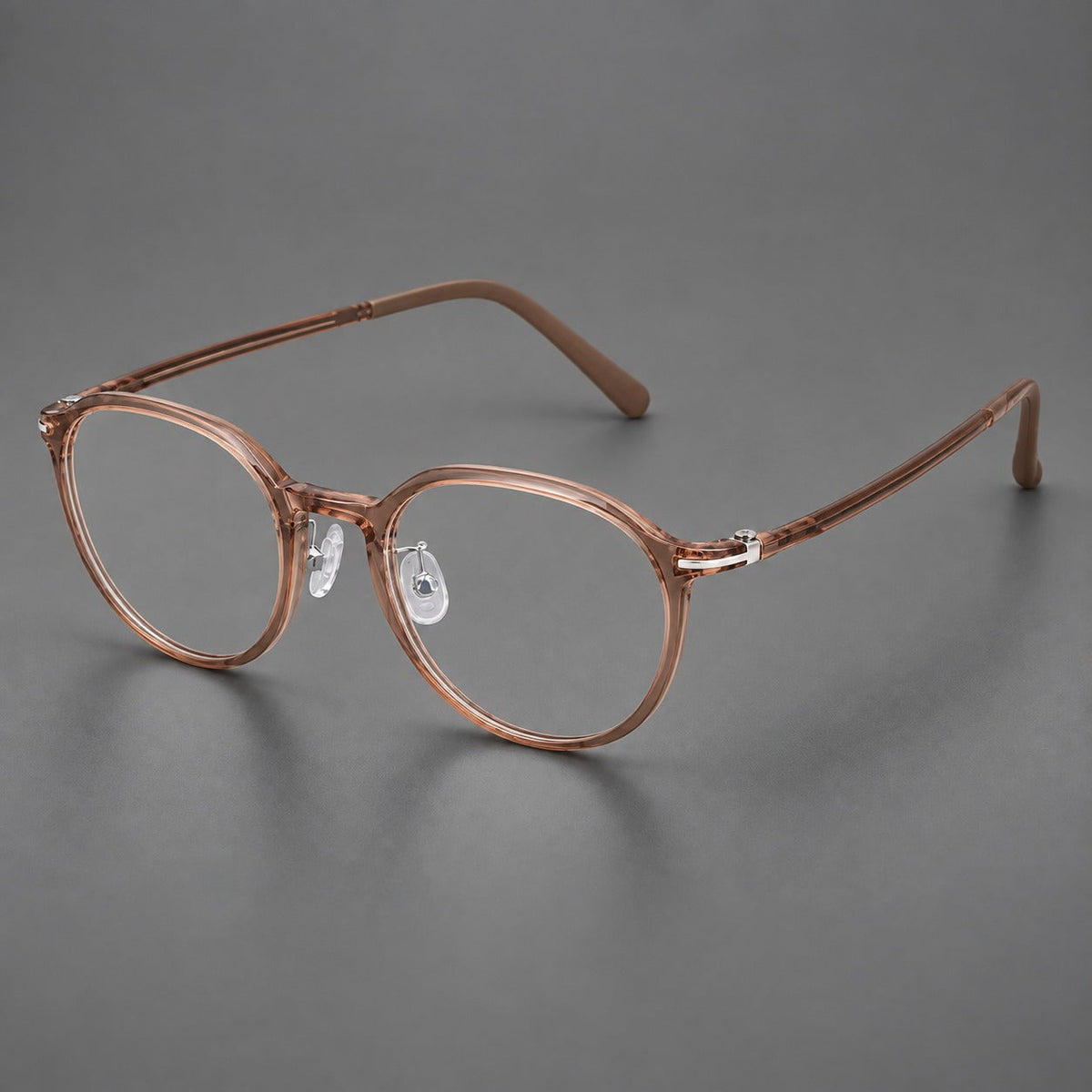 Compact round plastic eyeglasses with gently lifted corners and clear nose pads in Amber Tea, three quarter view