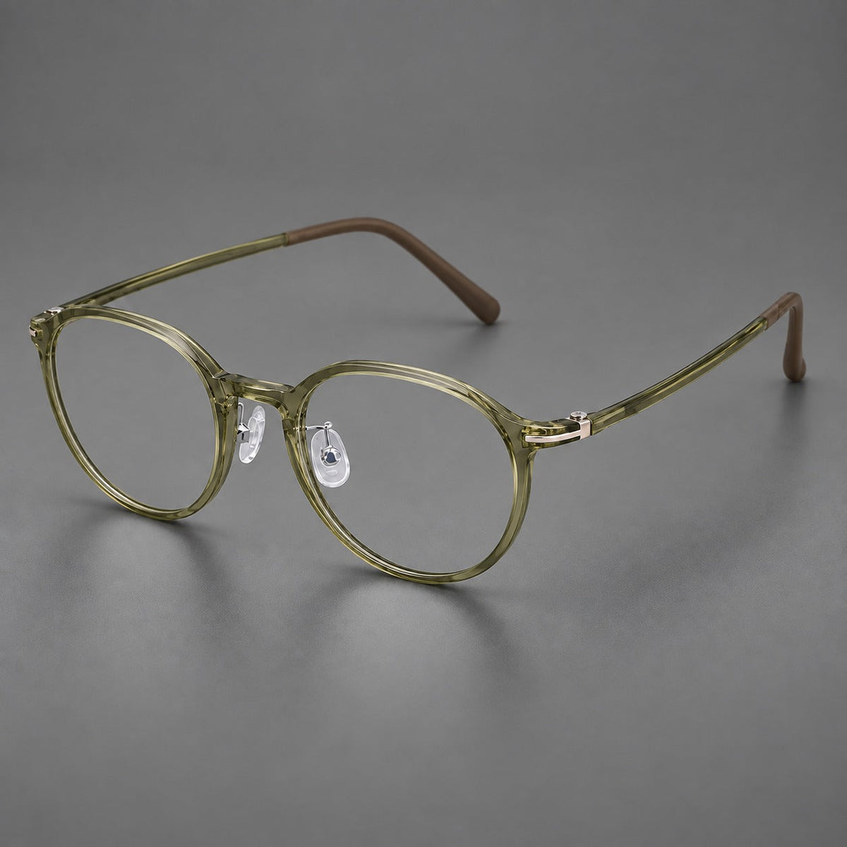 Compact round plastic eyeglasses with gently lifted corners and clear nose pads in Iced Green Tea, three quarter view