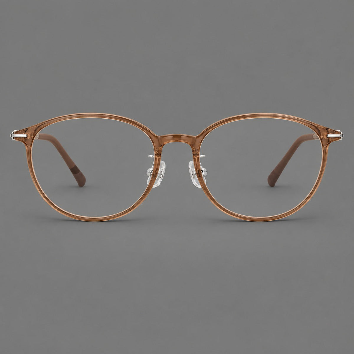 Slim oval plastic eyeglasses with a low profile and subtle metal corner accents in Honey Tea, front view