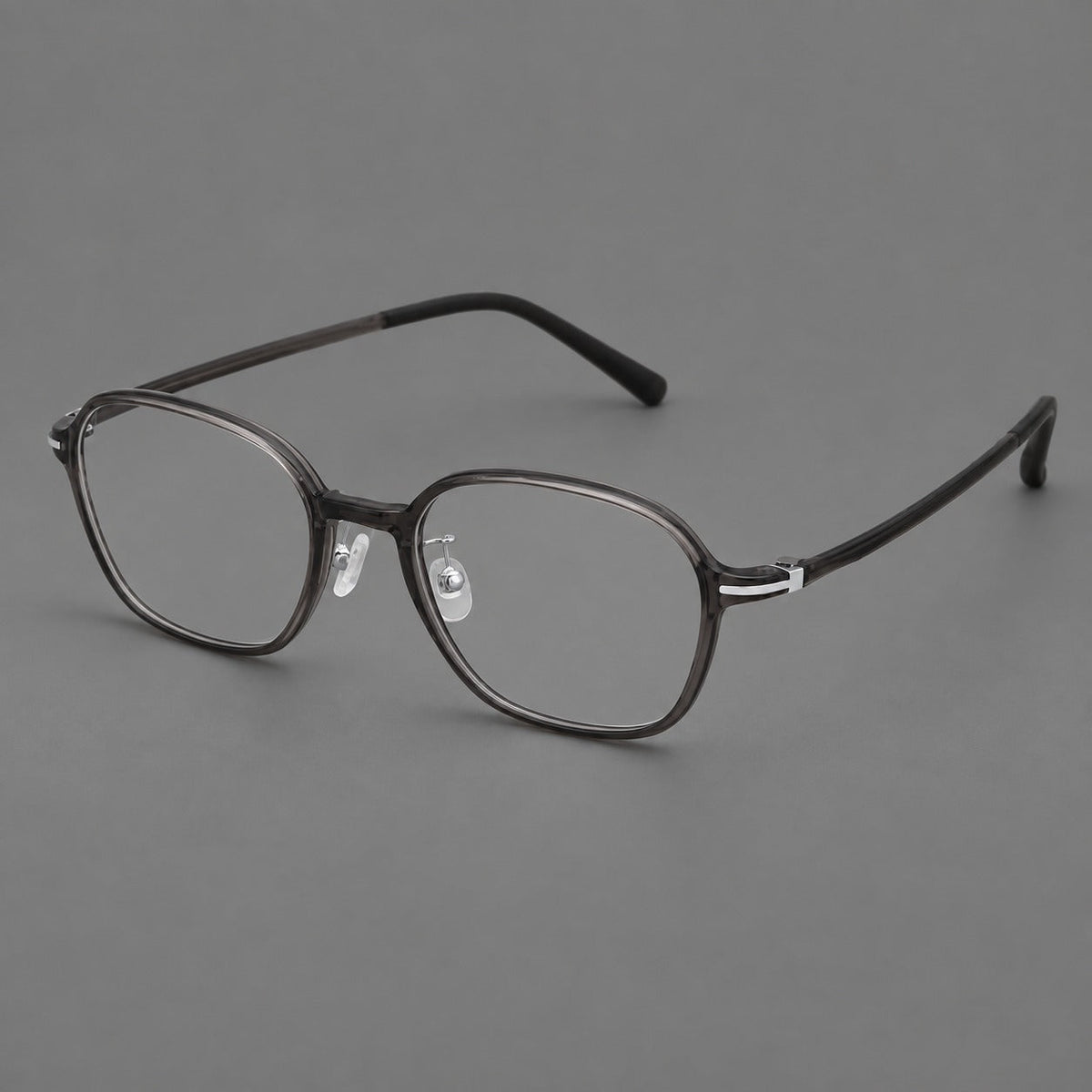 Rounded geometric plastic eyeglasses with softly angled rims and a curved bridge in Dark Gray, three quarter view