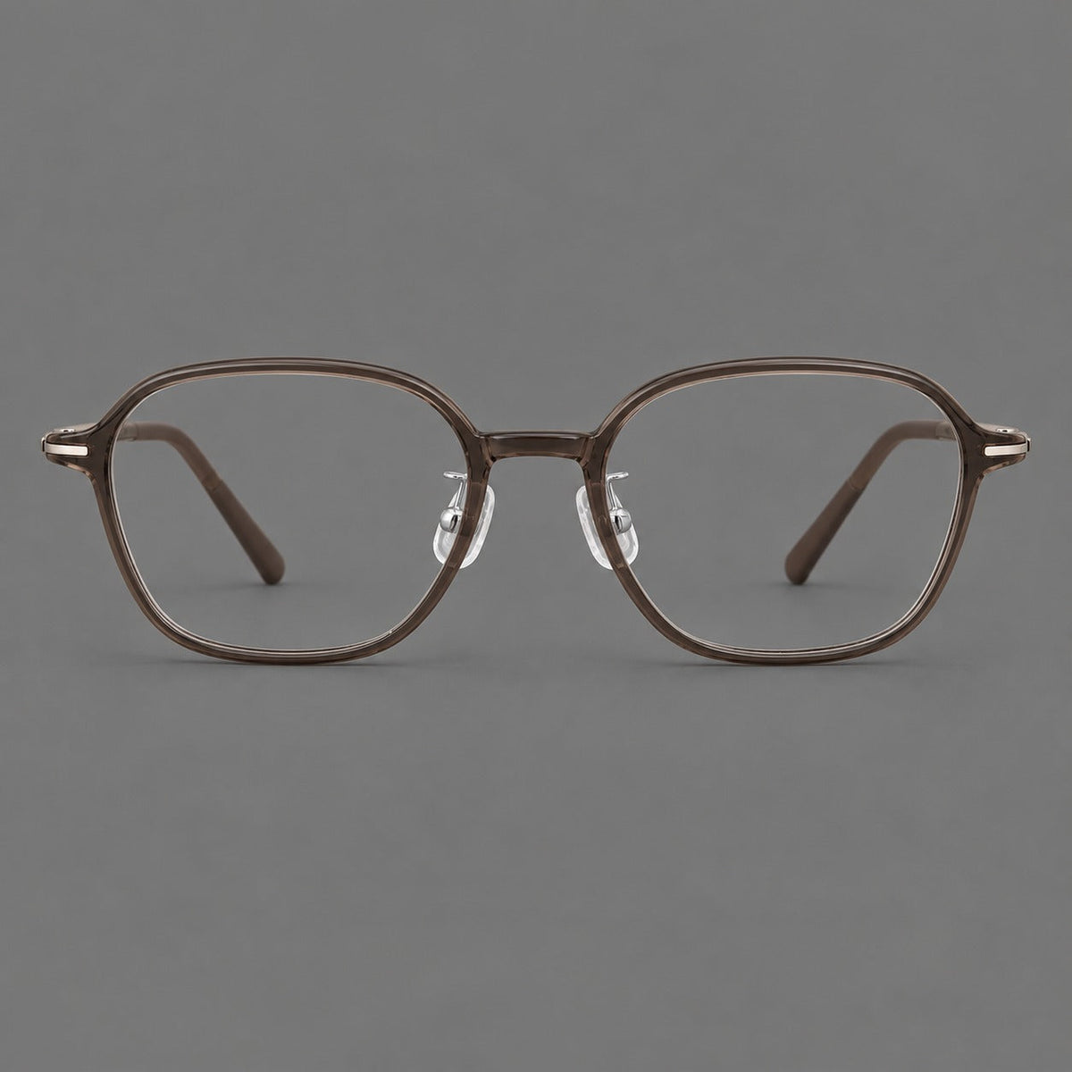 Rounded geometric plastic eyeglasses with softly angled rims and a curved bridge in Ink Brown, front view