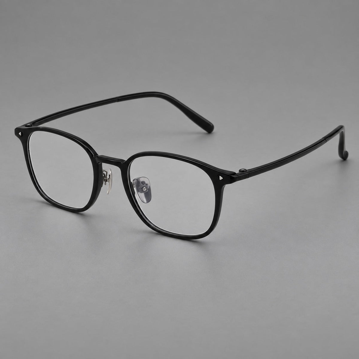 Retro square plastic eyeglasses with a curved bridge and triangular corner details in Glossy Black, three quarter view