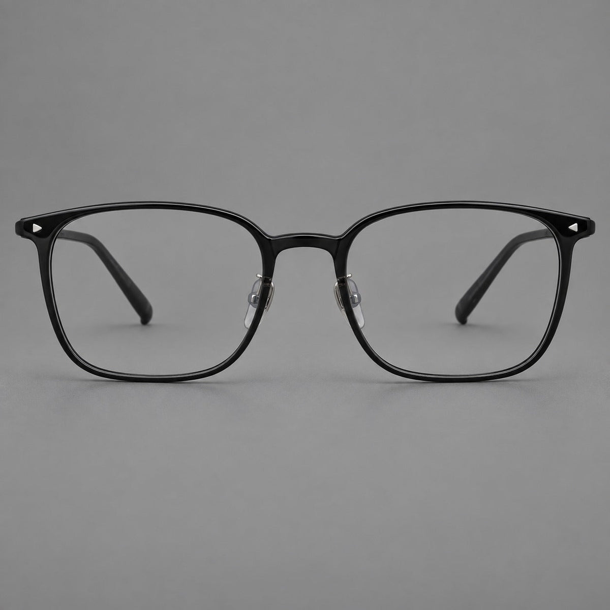 Classic soft square plastic eyeglasses with a gently curved browline and corner studs in Glossy Black, front view