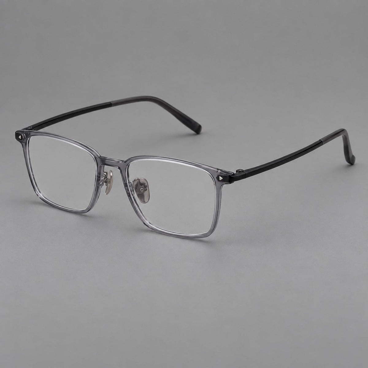 Clean rectangular plastic eyeglasses with flat lower rims and pointed corner details in Ink Gray, three quarter view