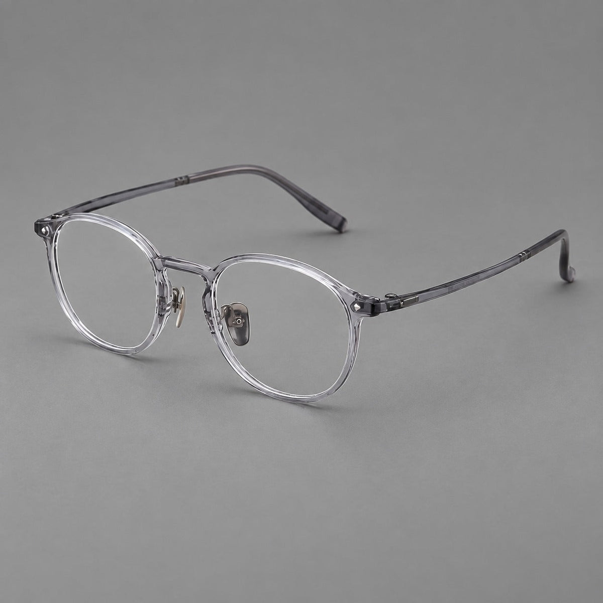 Vintage round plastic eyeglasses with a curved bridge and subtle triangular accents in Light Gray, three quarter view