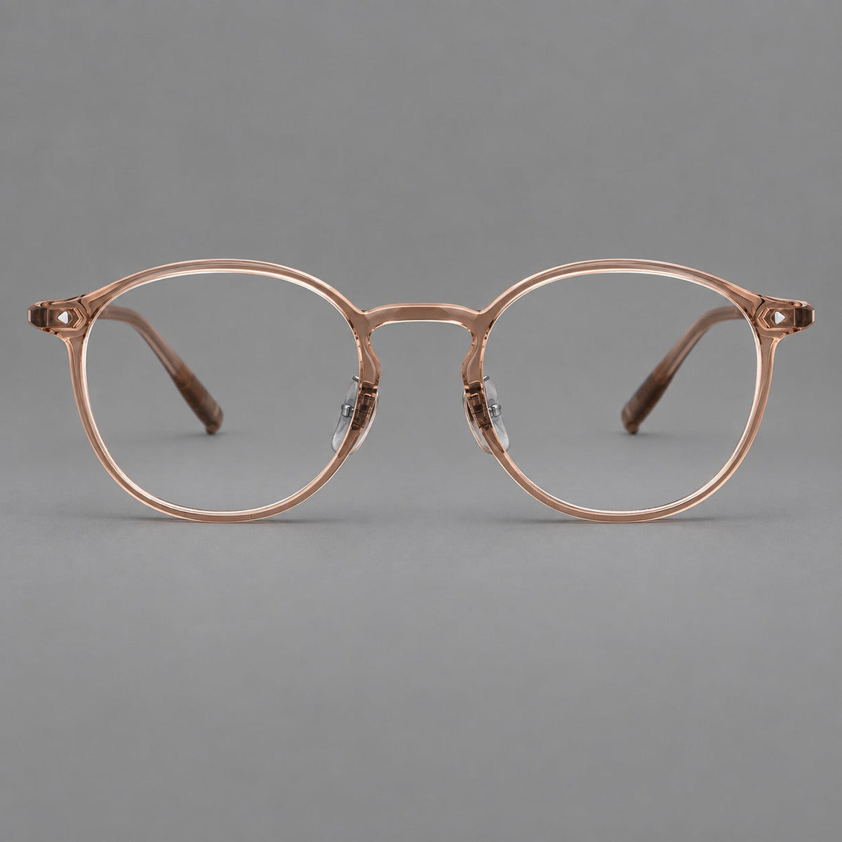 Vintage round plastic eyeglasses with a curved bridge and subtle triangular accents in Tea, front view