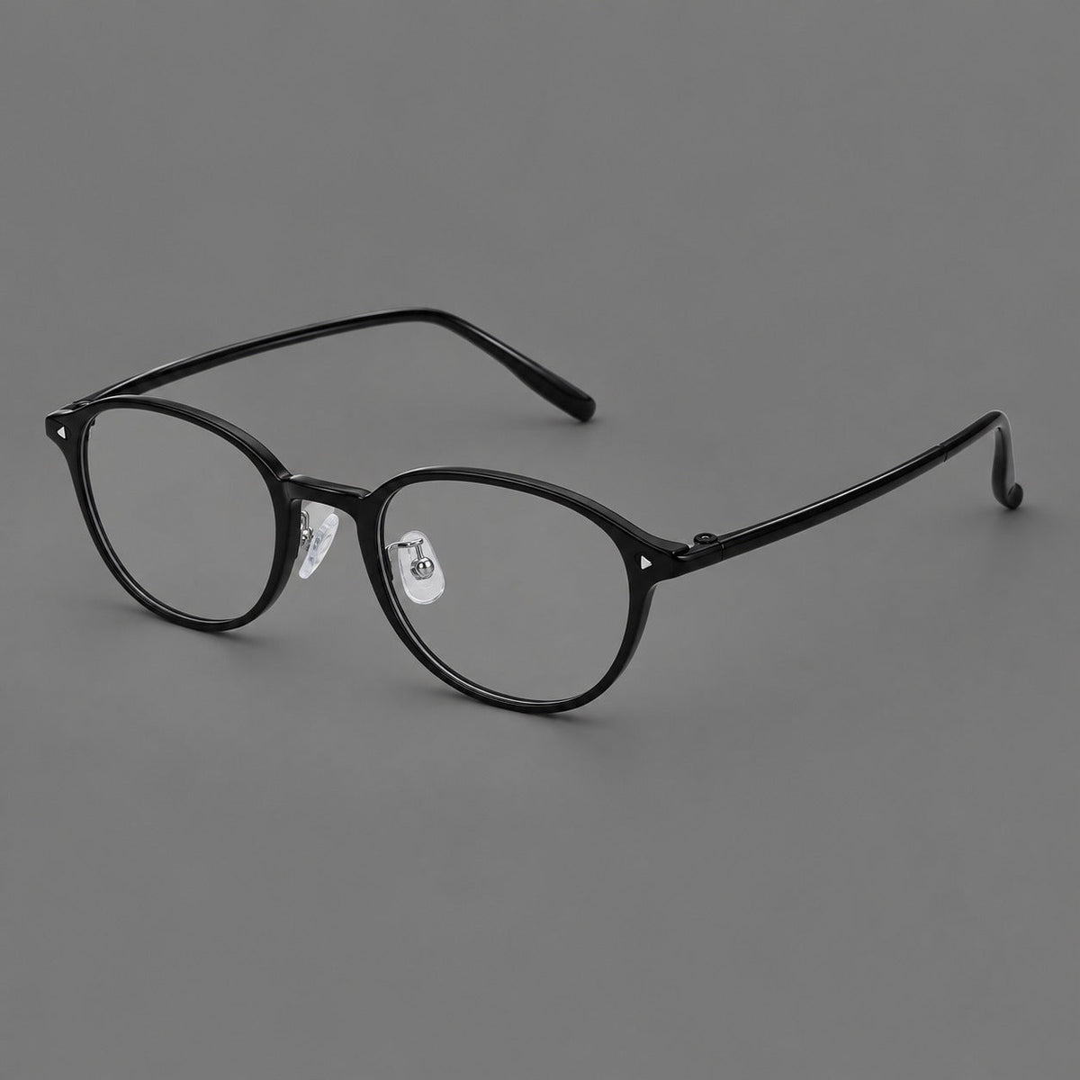 Panto plastic eyeglasses with a rounded silhouette and triangular corner studs in Glossy Black, three quarter view