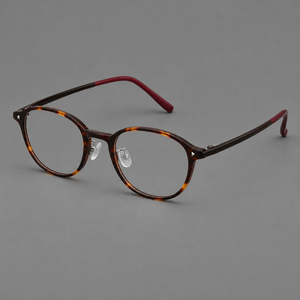 Panto plastic eyeglasses with a rounded silhouette and triangular corner studs in Tortoiseshell, three quarter view