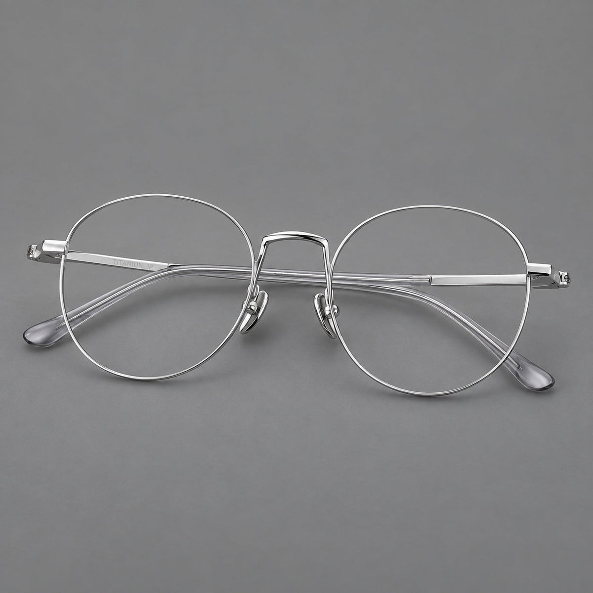 Retro round titanium glasses with a raised bridge and smooth corner shoulders in Silver, three quarter view