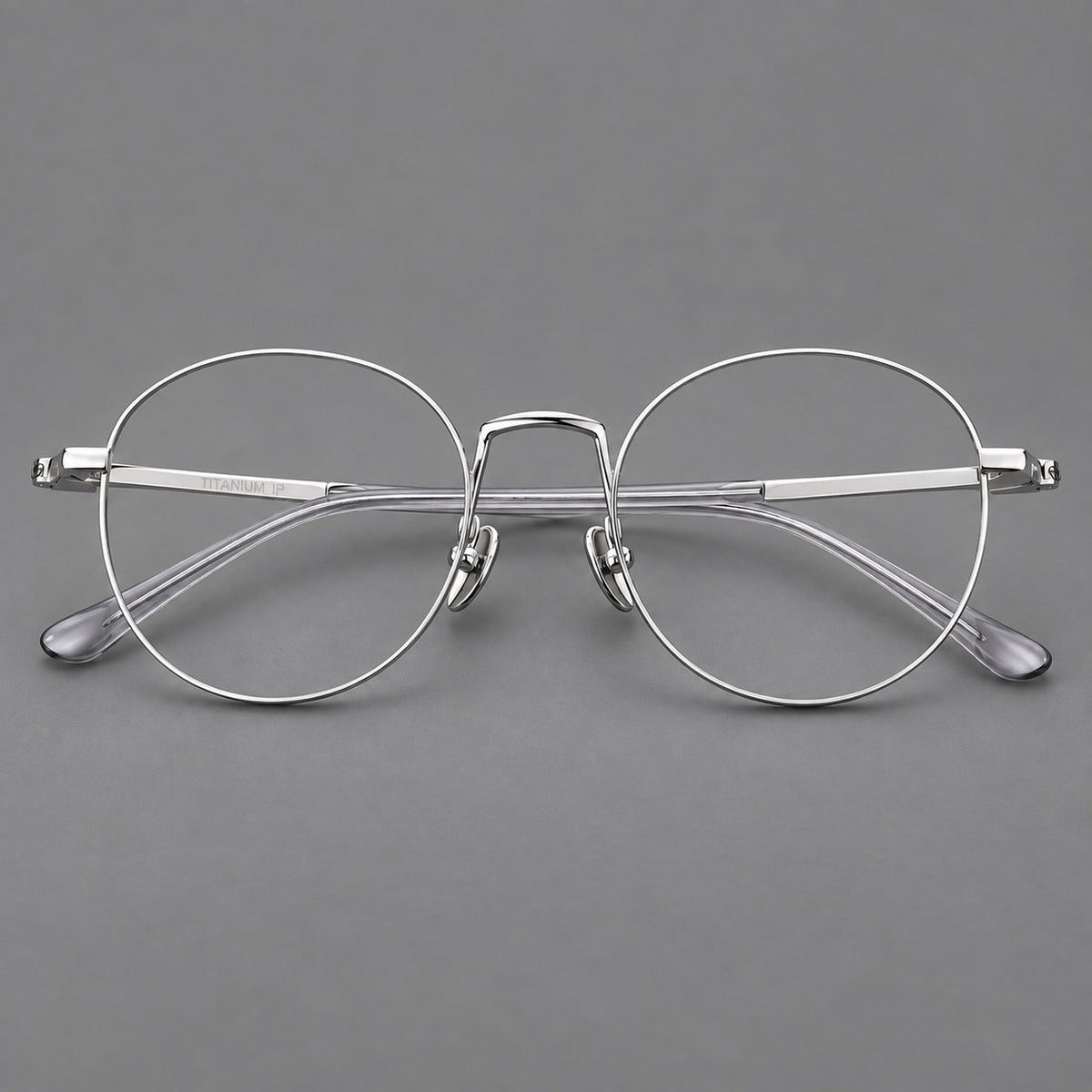 Retro round titanium glasses with a raised bridge and smooth corner shoulders in Silver, front view