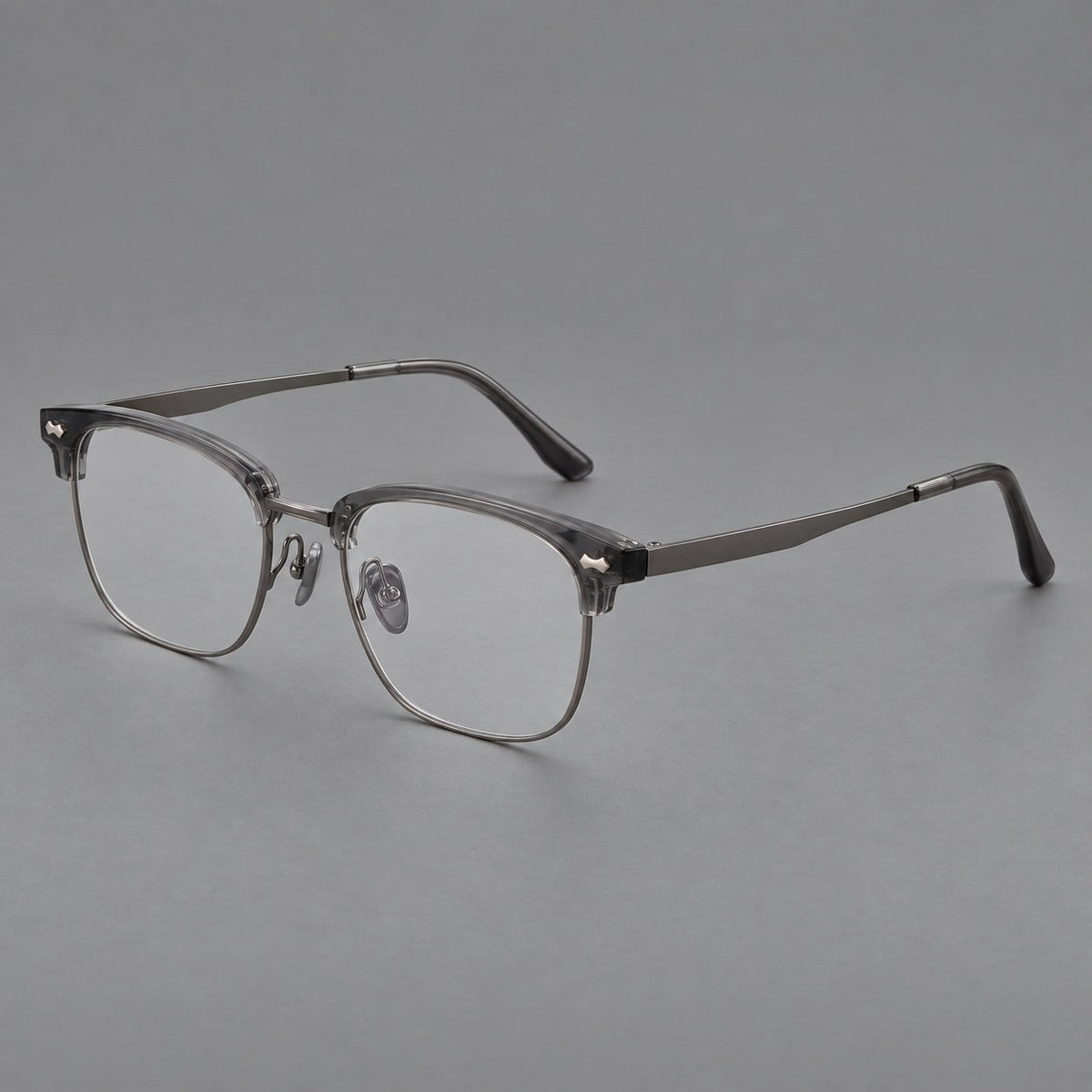 Classic browline titanium glasses with fine lower rims and subtle corner accents in Gunmetal, three quarter view