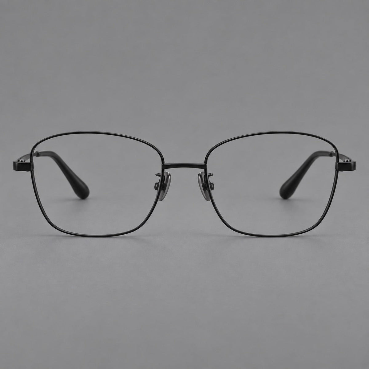 Soft square titanium glasses with angled upper corners and decorated hinges in Black, front view