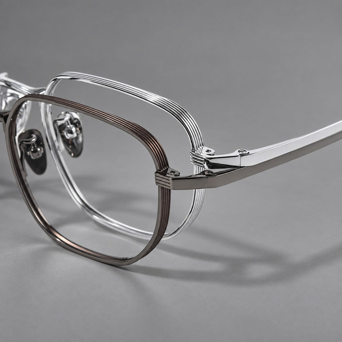 Retro square titanium glasses with rounded rims and finely grooved shoulders, frame details