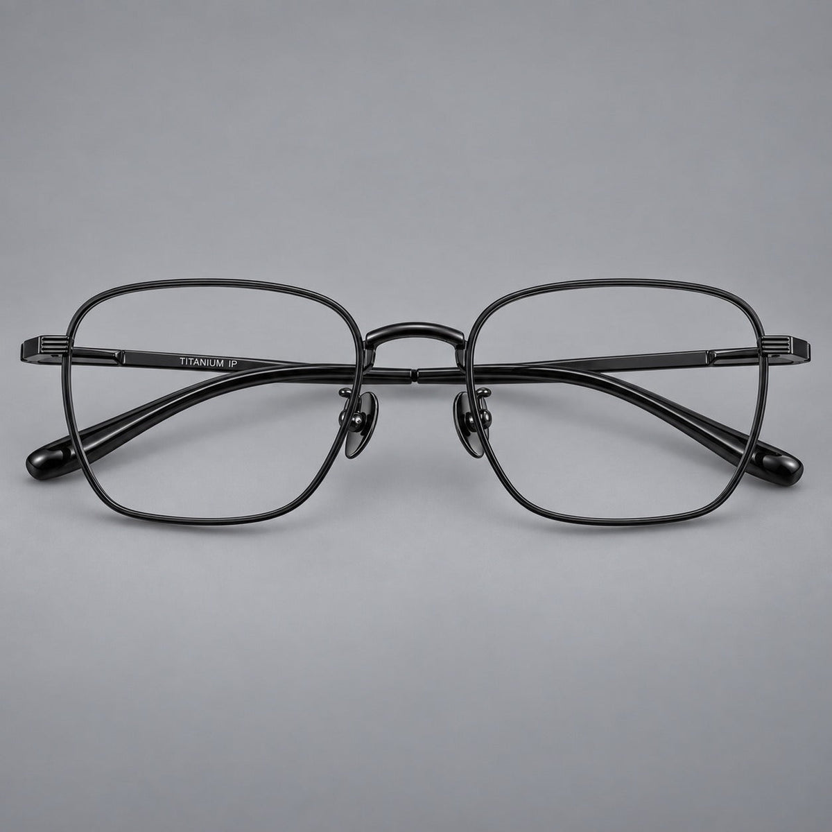 Deep square titanium glasses with a flatter brow and grooved outer shoulders in Black, front view