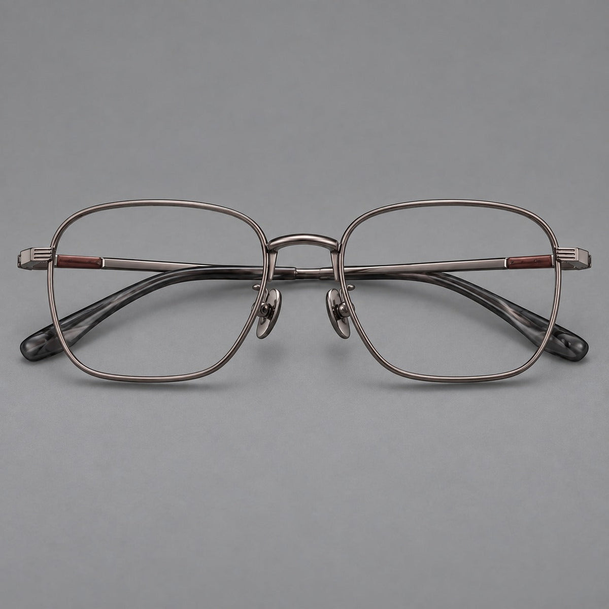 Deep square titanium glasses with a flatter brow and grooved outer shoulders in Gunmetal, front view