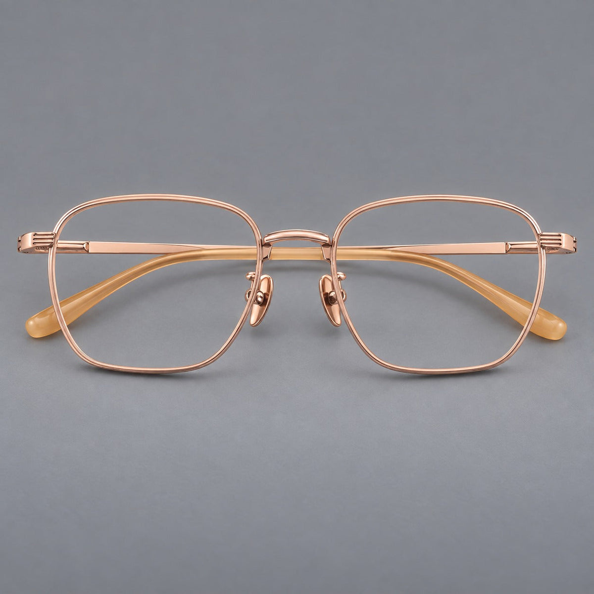 Deep square titanium glasses with a flatter brow and grooved outer shoulders in Rose Gold, front view